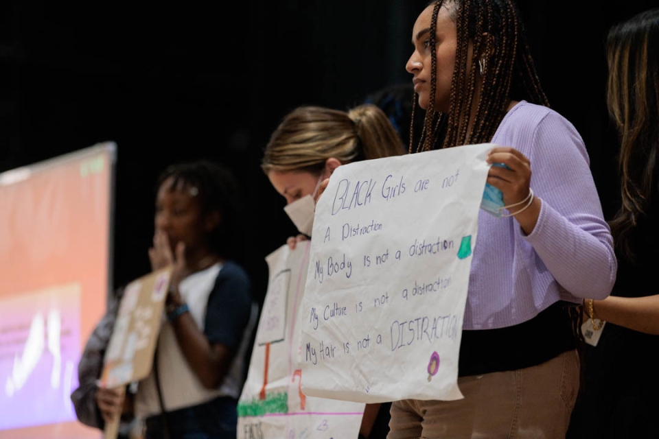 Students holding up signs 