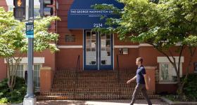 A person walking in front of the Graduate School of Education and Human Development building on GW's Foggy Bottom campus.